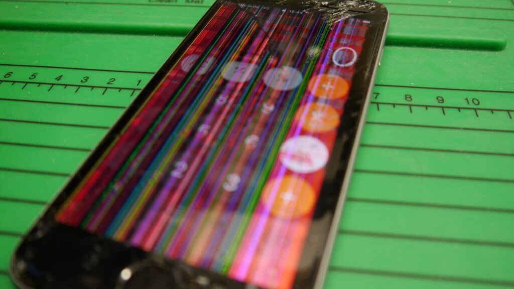 Handy mit kaputtem Display, farbige Streifen sind dem Bild überlagert